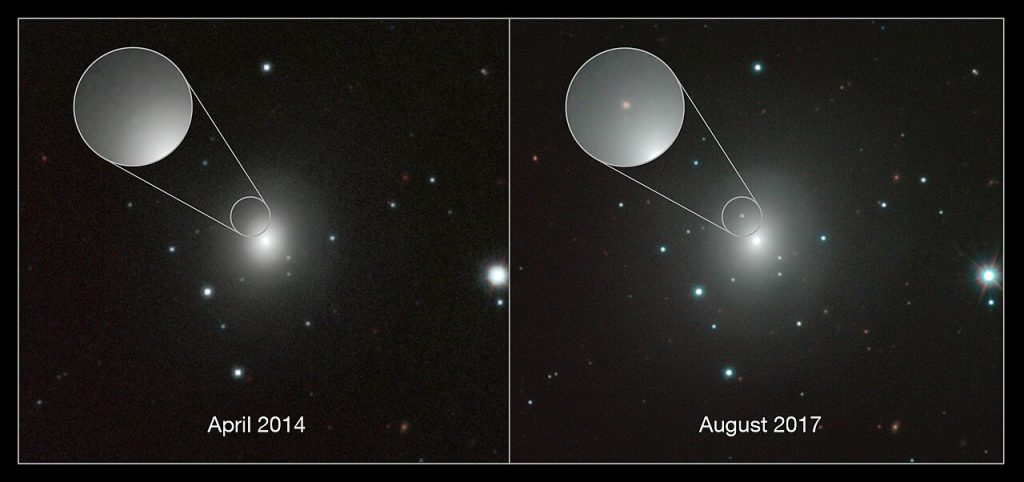 Two side-by-side telescope views of the same fuzzy, glowing galaxy among scattered stars on a black sky. In the left panel, labeled April 2014, a magnified circle near the galaxy’s bright center shows only smooth glow. In the right panel, labeled August 2017, the same magnified spot shows a small new reddish dot.