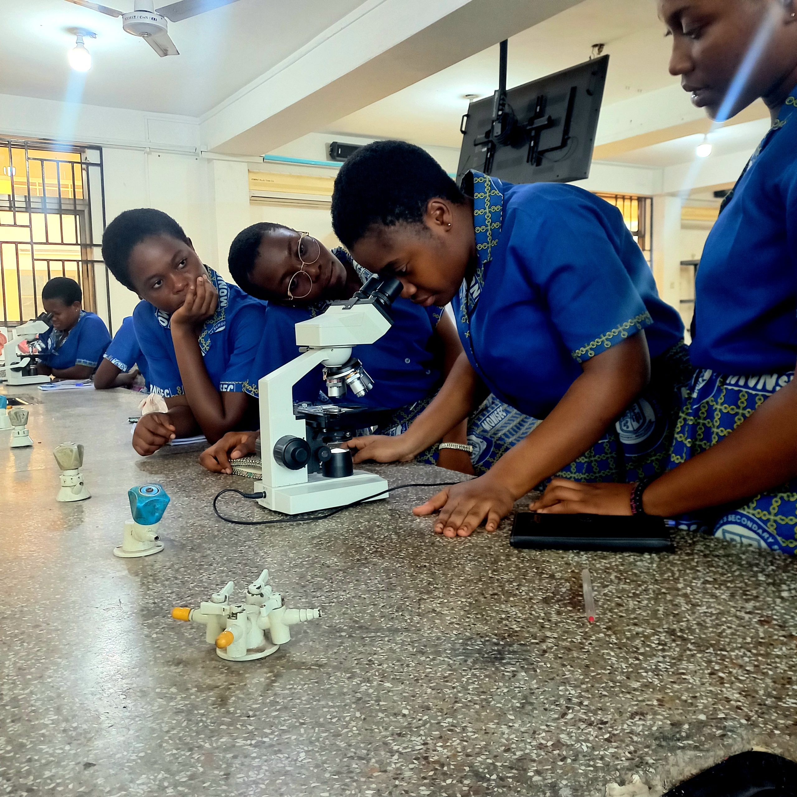 Students using a microscope.