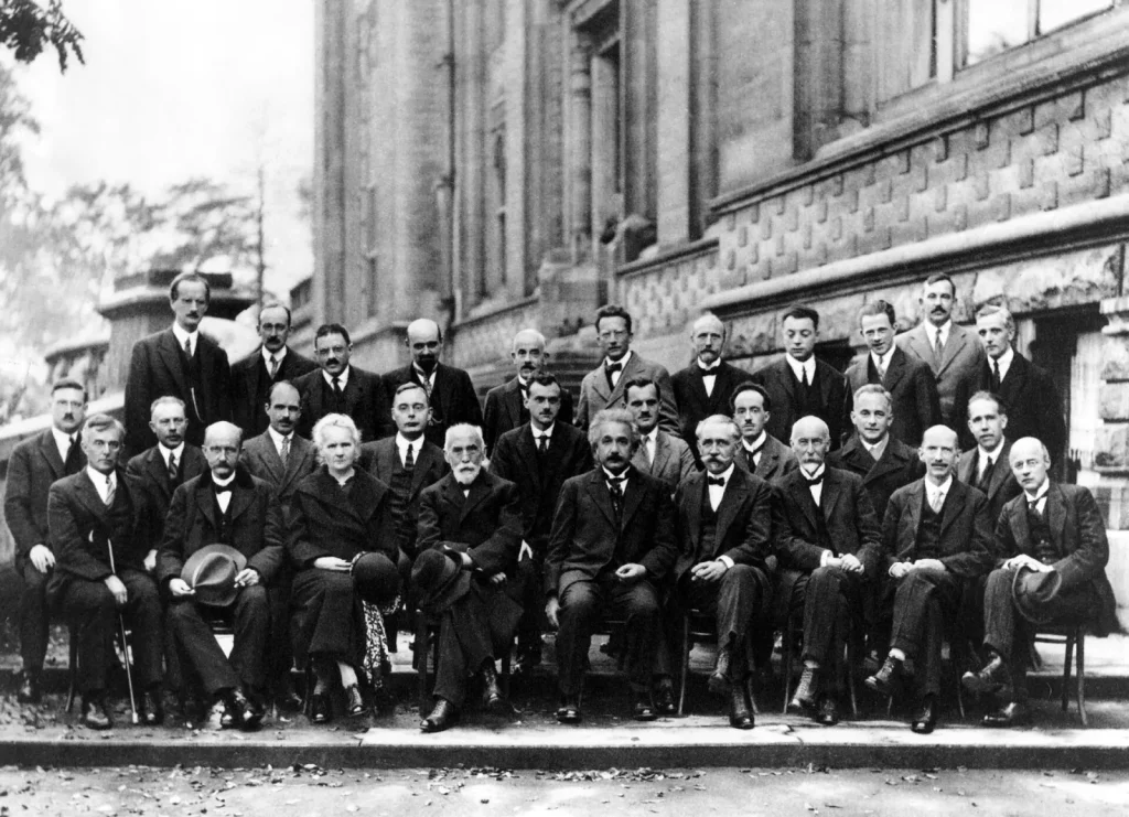 Black-and-white group photograph of the physicists at the 1927 Solvay Conference in Brussels, with Albert Einstein seated in the centre of the front row