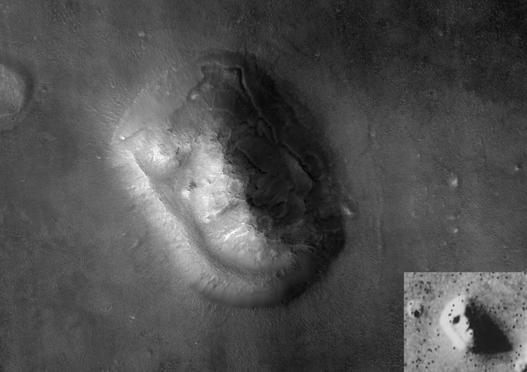 Grayscale overhead view of a rugged, oval-shaped mesa on Mars with eroded slopes and no facial features. A small inset at lower right shows the blurry 1976 Viking image of the same hill, where shadows resemble eyes, a nose and a mouth.